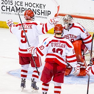 Frozen Four, here we come! Terriers Matt Grzelcyk (COM'16), Danny O'Regan (COM'16), and Doyle Somerby (CGS'15) converge on goalie Matt O'Connor (SMG'16) after BU's 3-2 win over Minnesota Duluth in Saturday's NCAA Northeast Regional final in Manchester, N.H. The Terriers are on their way to the NCAA championship at Boston's TD Garden April 9 and 11. Photo by Brian Kelley/BU Athletics