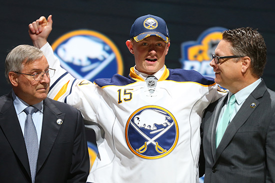 Jack Eichel celebrates with team executives after being drafted by the Buffalo Sabres