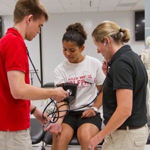 BU athletic training students Cyprien Jungels, red shirt, Amanda Fraden, white shirt and staff Erica Shaya, black shirt.