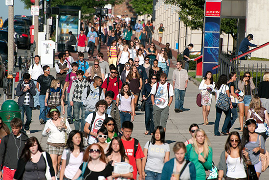 Students walk along Commonwealth Avenue on the Boston University Charles River Campus