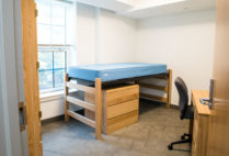 Myles Standish gets a facelift. Superimposed image of a student from over 15 years ago on top of a photo of a recently refurbished room.
