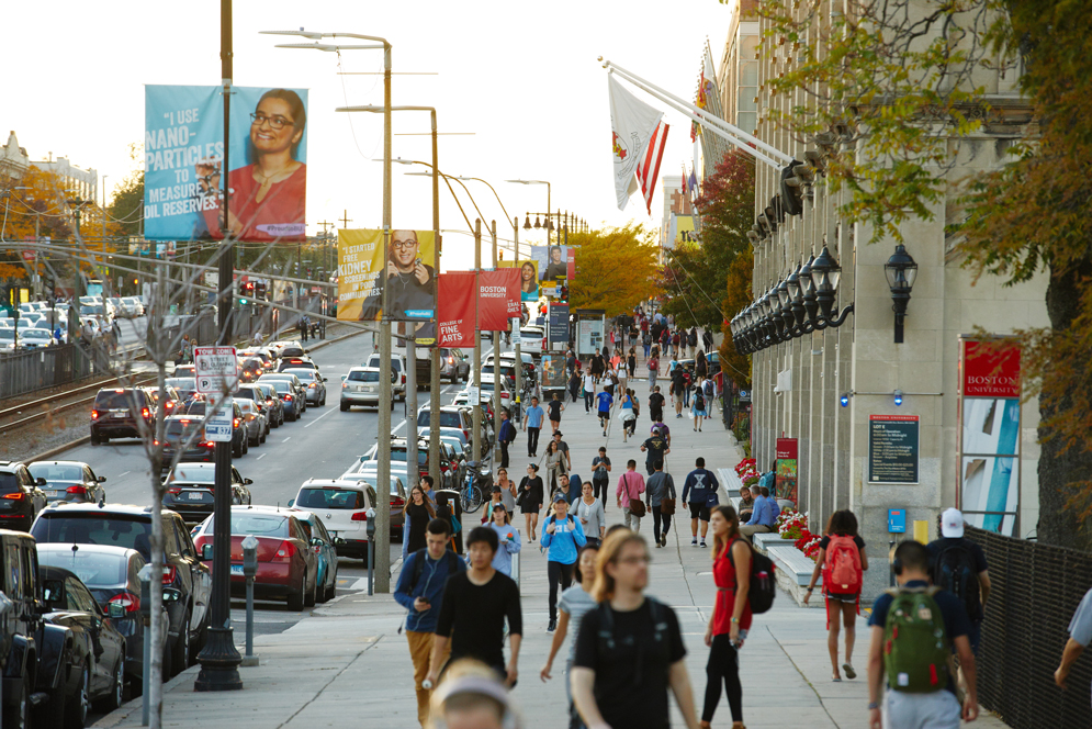 Students walk along Commonwealth Ave. on the Boston University Charles River Campus