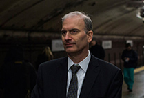 Portrait of Craig Avedisian, winner of the NYC MTA Genius Transit Challenge, standing in a New York City subway station