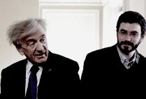 Professor Elie Wiesel sits talking with his teaching assistant, Ariel Burger.