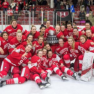 The BU women's ice hockey team poses with the Beanpot Trophy after winning the 41st Annual Beanpot Tournament Championship.