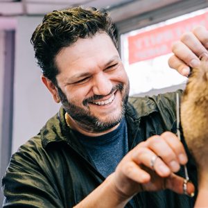 University Barber Shop owner Rino DeStefano gives a haircut