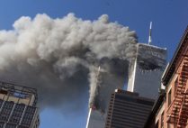 the twin towers smoking as seen from the street a few blocks away
