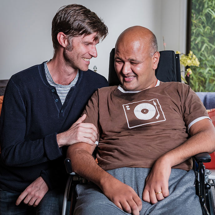 Craig Cloutier and Rahul Desikan laugh and pose for a photo together.