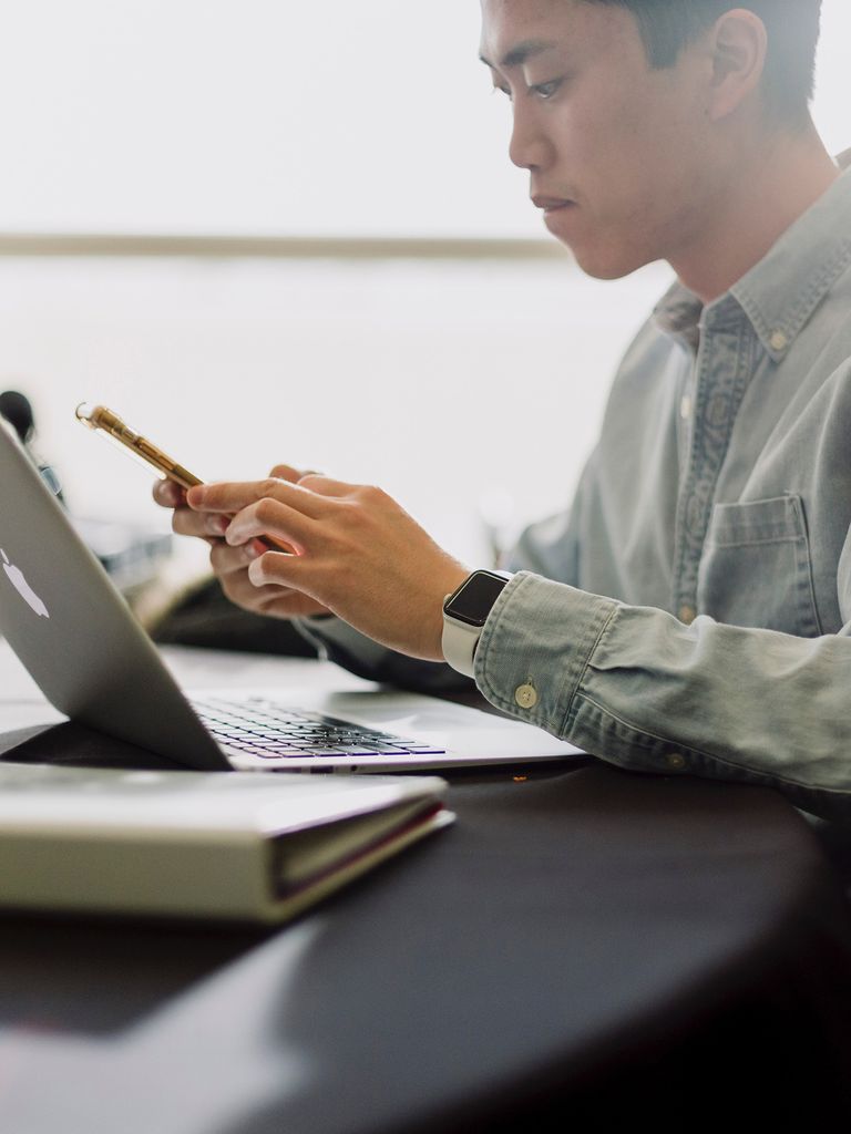 Man on phone with computer