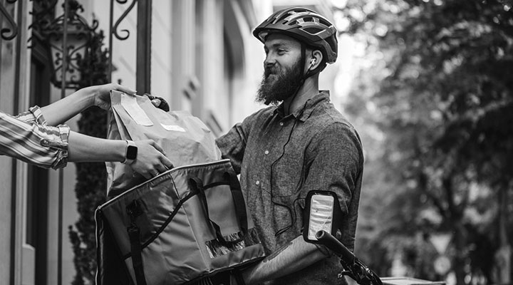 Man on bicycle making a food delivery