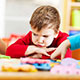 Child pouting while playing with others
