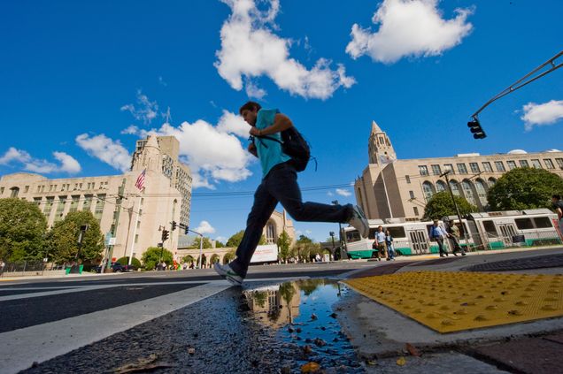 Boston, Massachusetts<br /> Students navigate the puddles on Commnoweath Avenue near Marsh Plaza on the Boston University Campus.