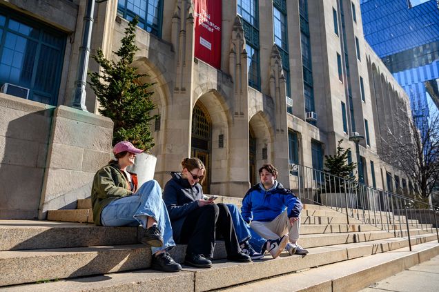 A group of students lounges outside of CAS early on March 29, 2023.