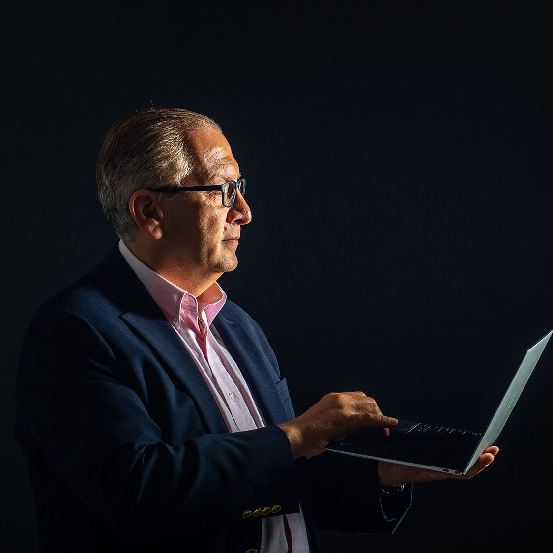 Photo of BU CDS Associate Provost Azer Bestavros using a laptop