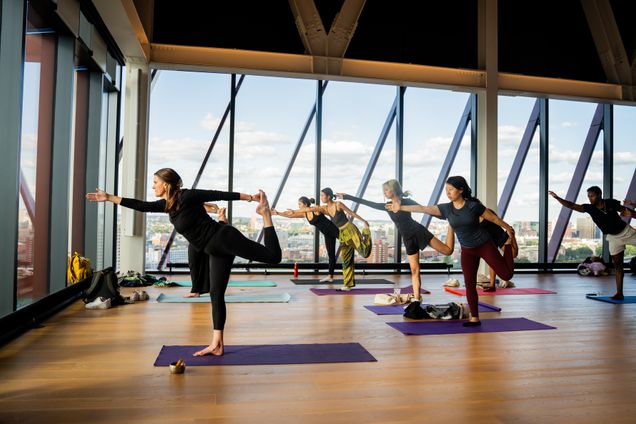 Photo of people doing yoga on the Boston University Center for Computing & 数据科学 17th floor