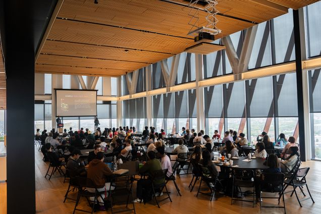 Photo of group of people gathered at tables on the BU Center of Computing & 数据科学 17th floor event area