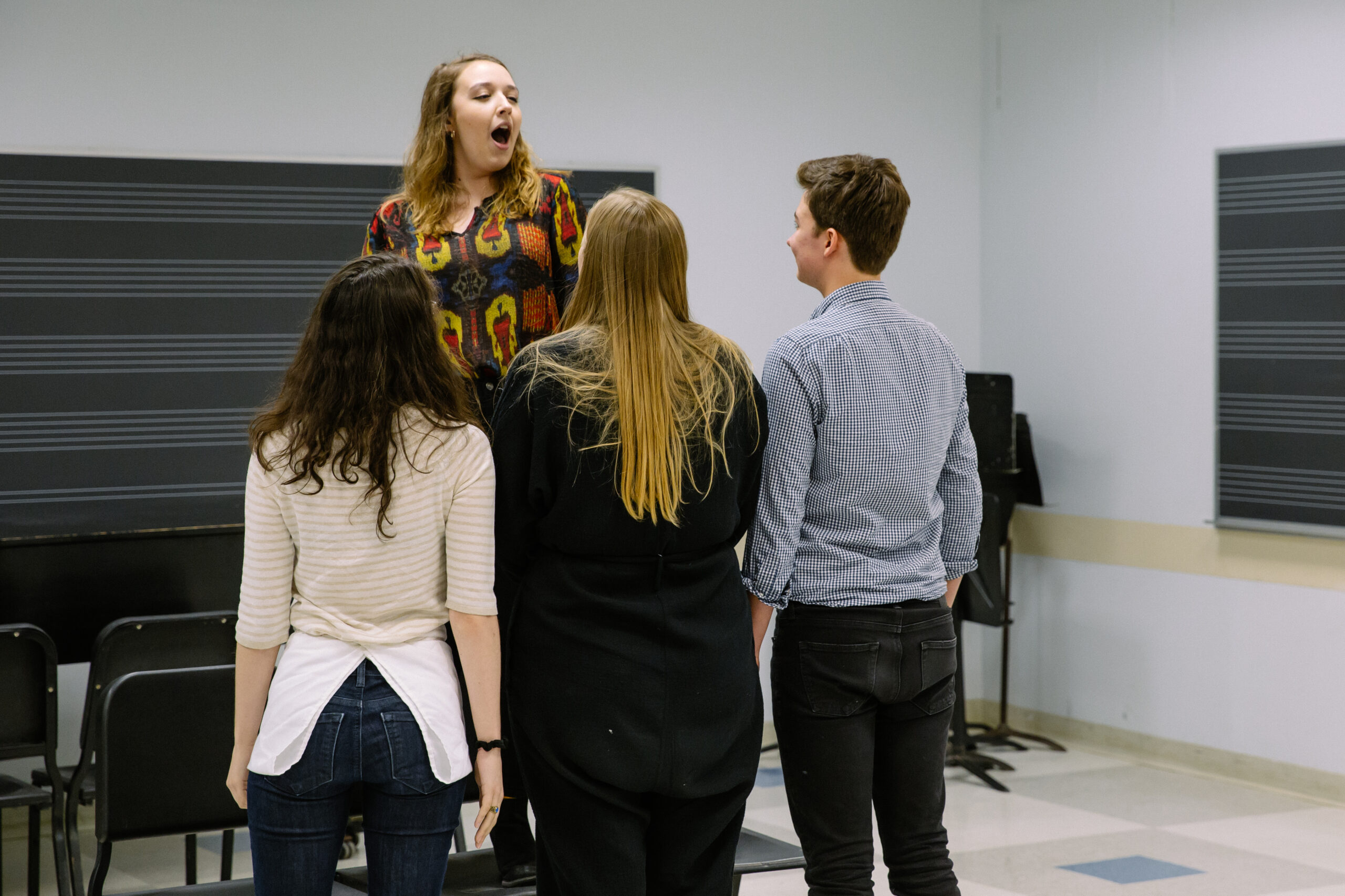 Students singing in a classroom