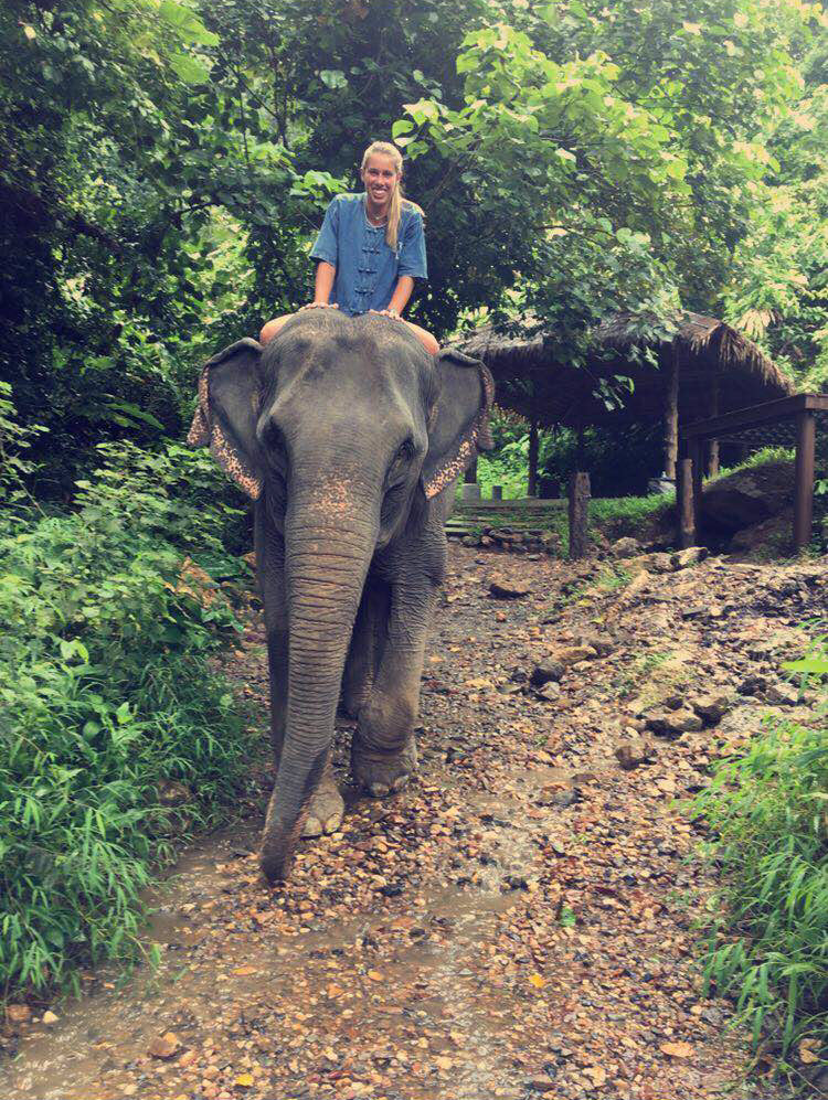 Nicole Pikulik riding an elephant