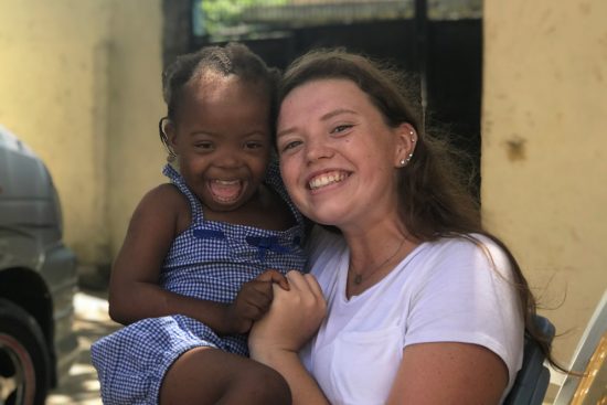 Tess holding three-year old Ramla, both with huge smiles