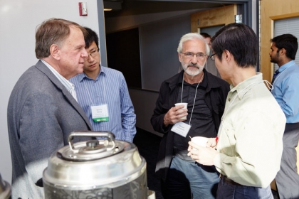 Professor Michael Caramanis (ME, SE) (second from right), who chaired the symposium's first session on control and optimization of electric power networks, with University of Maryland Professor John Baras (ECE) (left), BU 系统工程 PhD student Bowen Zhang (second from left) and California Institute of Technology Professor Steven Low (ECE) (right) during a break.