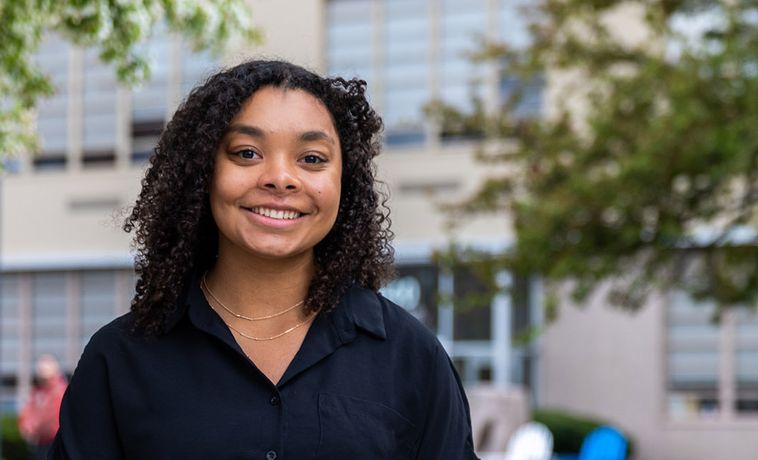 Jali Griesbach smiling portrait outside on the COM Lawn.