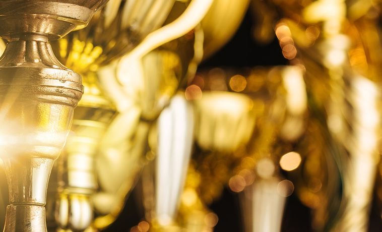 Group of the golden trophies in sparkling light.