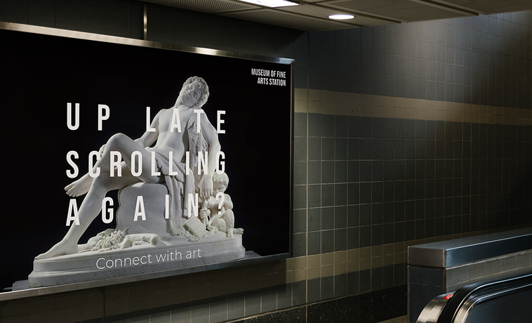 Poster framed near subway escalator.