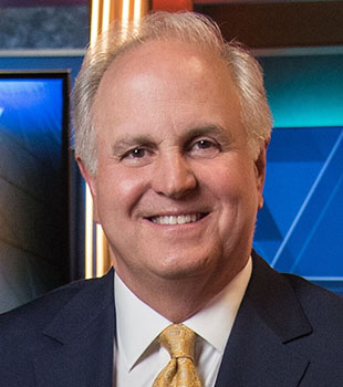 Bill Fine smiling portrait in WCVB studio.