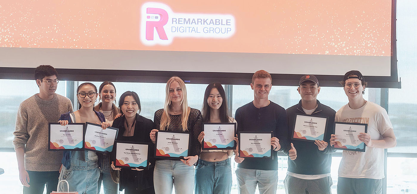 Group of students holding framed certificates.