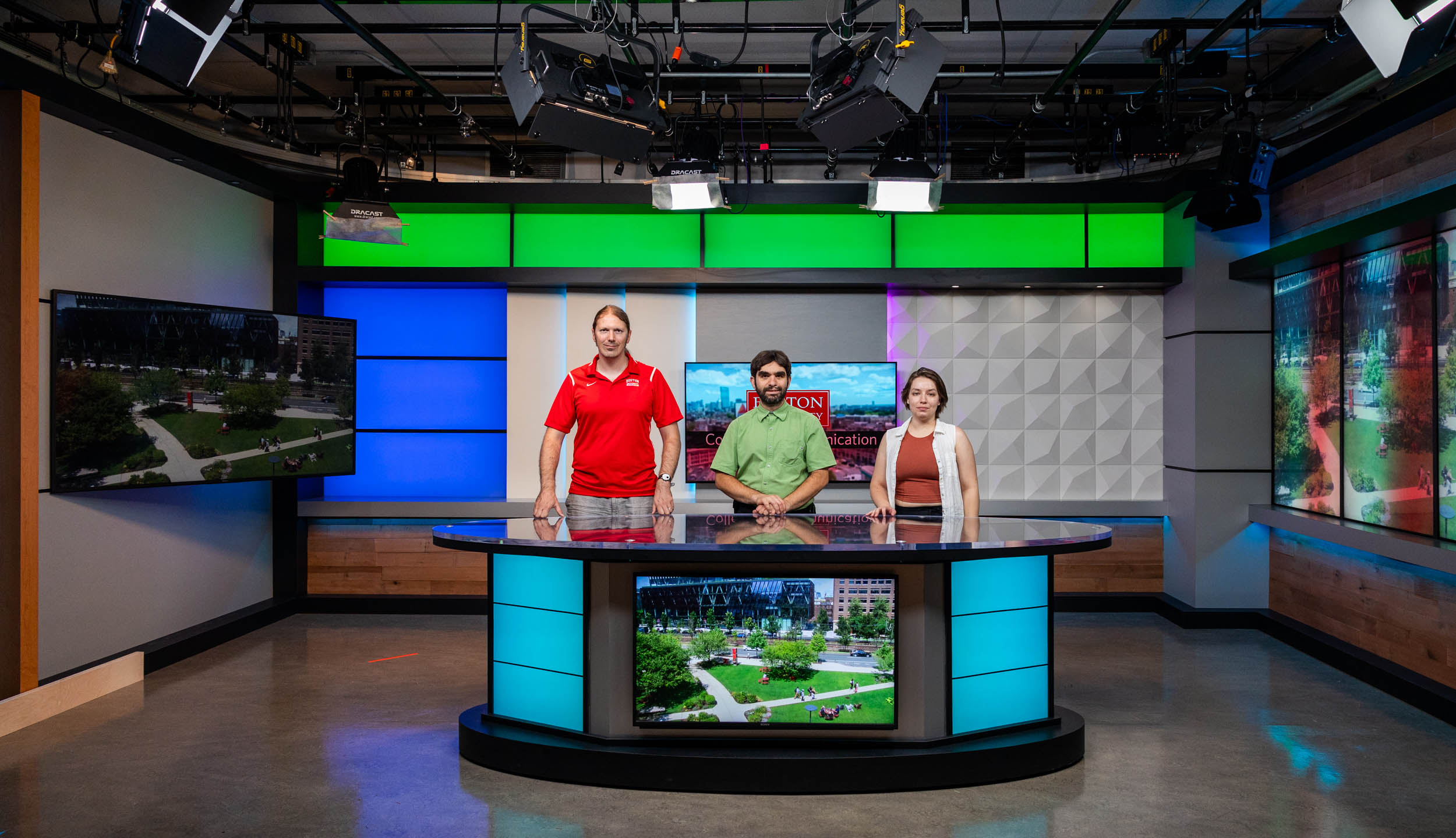 Tristan Olly (lead studio engineer), Jake Kassen (technical operations manager) and Emma Picht (COM ’23) (media technician) pose at the new anchor desk in Studio West. Photo by Guramar Lepiarz.