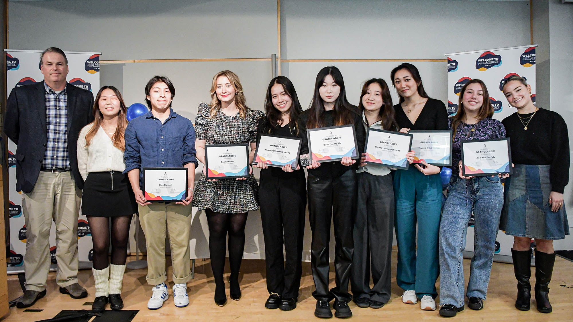 The Grandlabbie Award recipients pose for a picture standing while holding their award plaques.