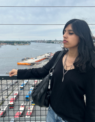 Lakshmi looking away from camera with river in background