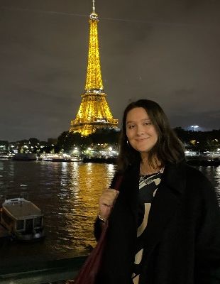 Tess smiling in front of Eiffel Tower