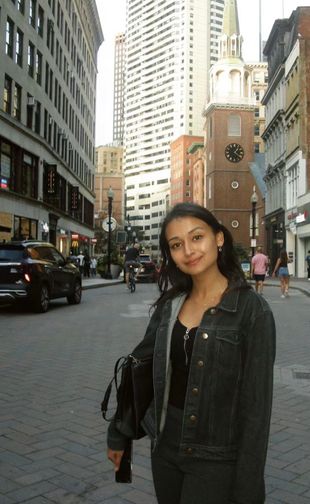 Ahalya smiling in city street
