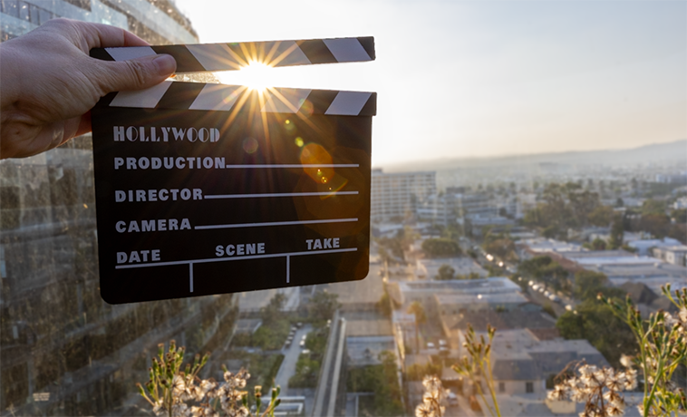 Clapper board with setting sun in the background.