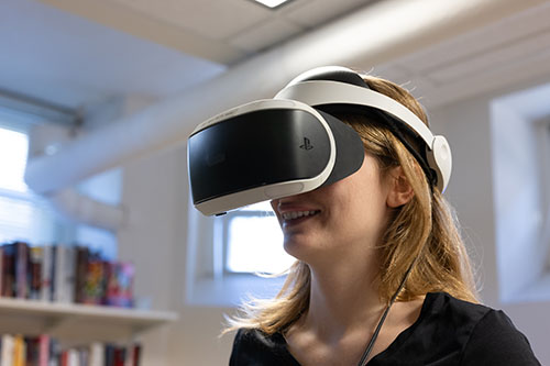 Woman wearing virtual reality helmet. 