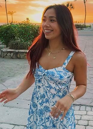 Portrait of Katie Alzapiedi with tropical sunset in background.