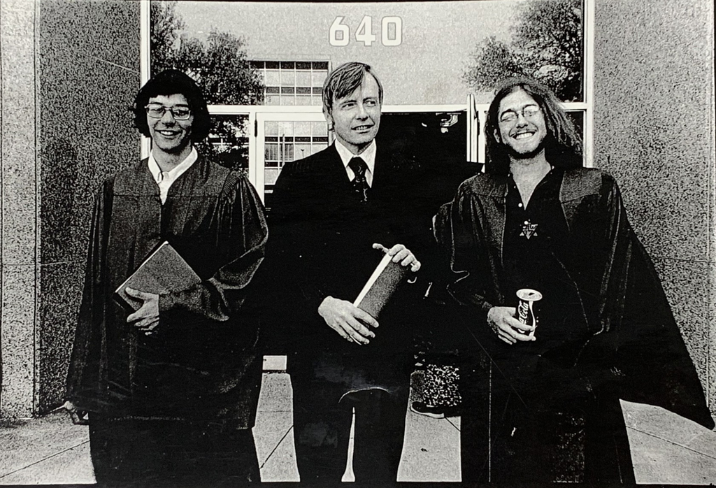 James Brann and two other men in graduation robes