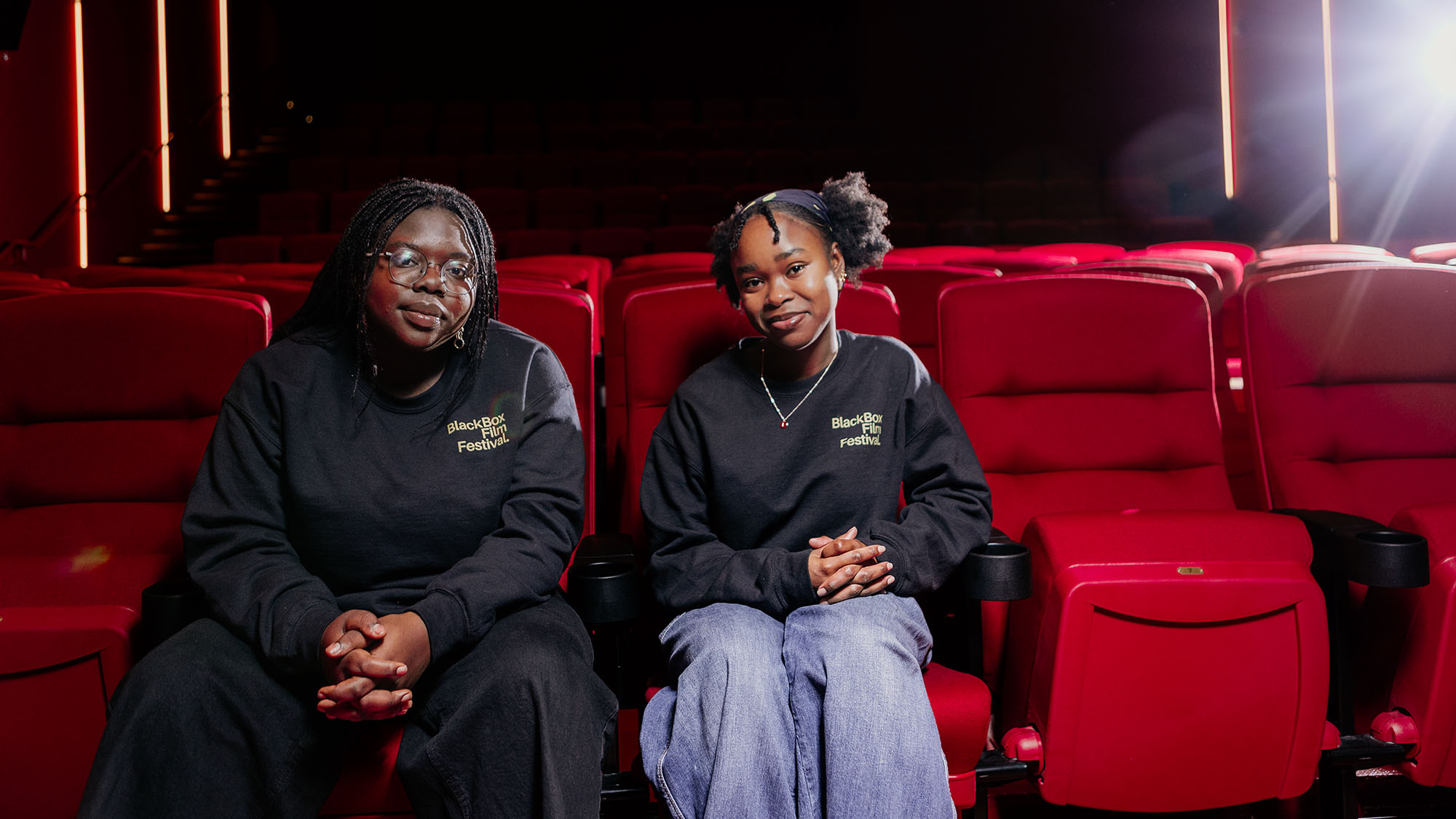 Lynn and Lydia in theatre seats.