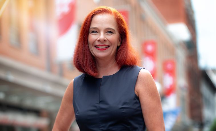 Catherine Tait smiling portrait outdoors.