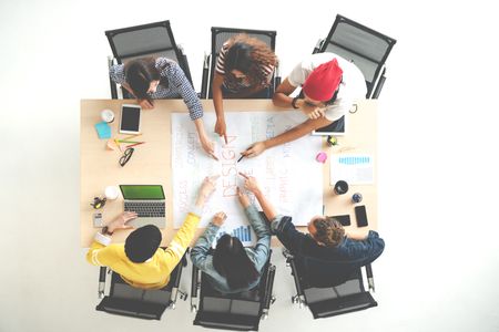 Group of students working on a project from a top view