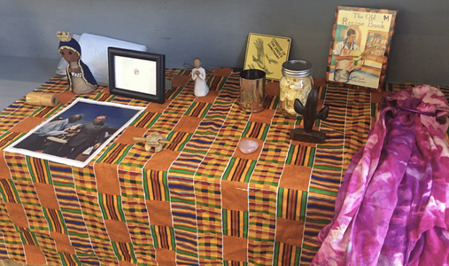 Various meaningful objects shared by a group at a community altar created by DAC participants at the first meeting