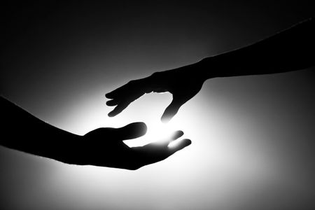 Image of two people about to hold each other's hands