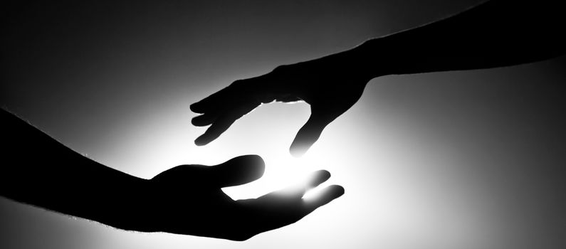 Image of two people about to hold each other's hands