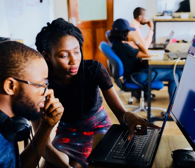 Two black people working on something