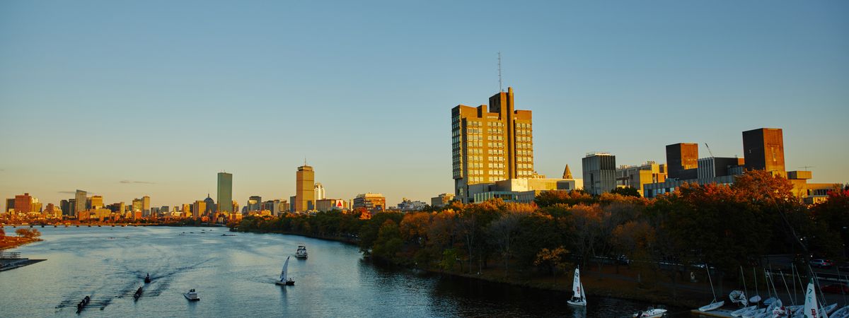 wide shot of Charles river at Sunset with rowers and sailers on water