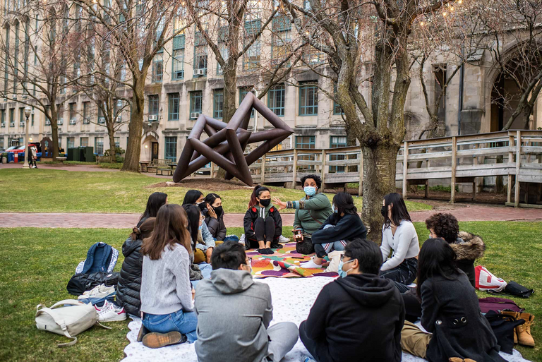 Students talk on BU Beach