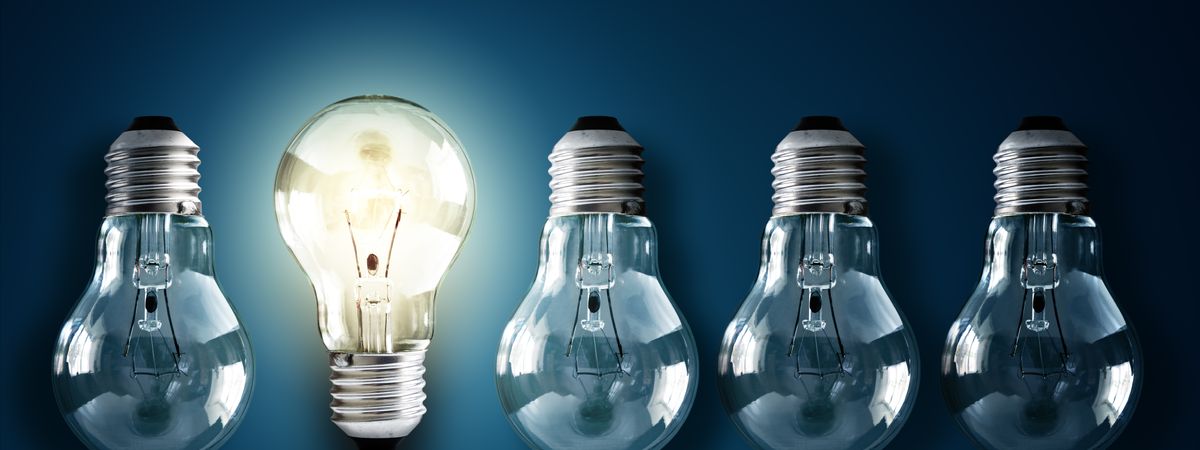 Illuminated Light Bulb In A Row Of Dim Ones