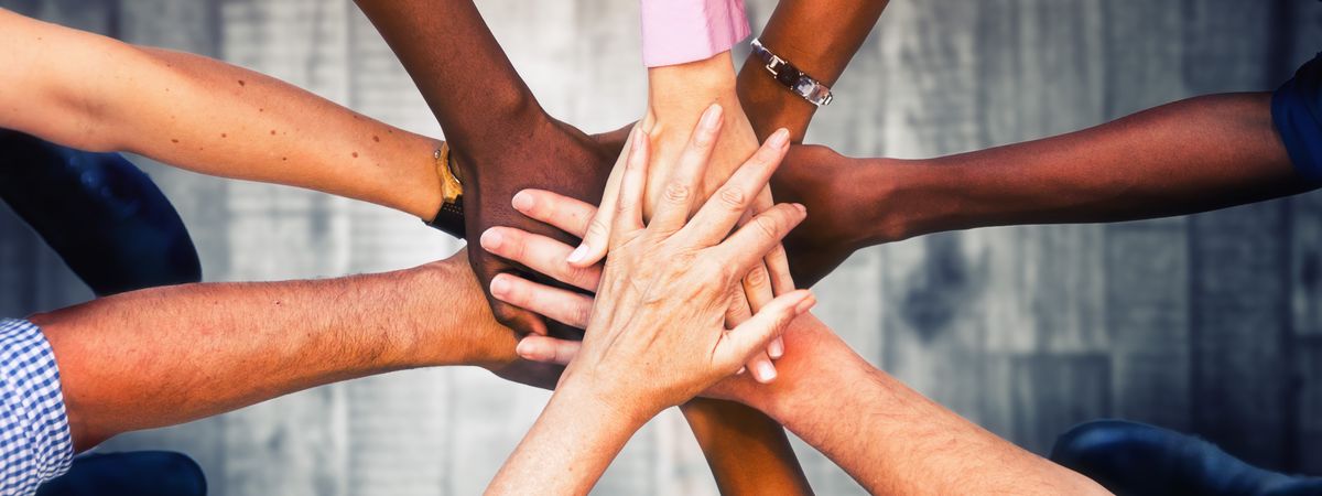 Nine People Putting their Hands Together