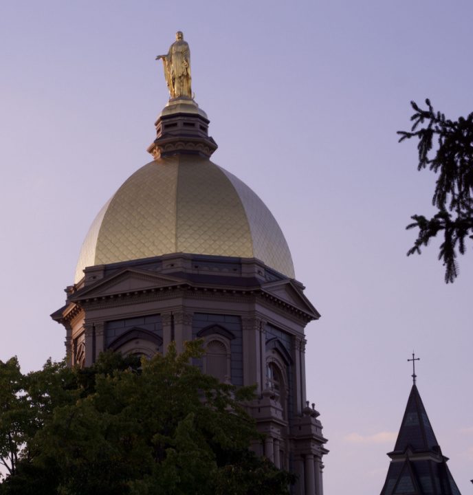 The top of the Main Building of the University of Notre Dame is pictured to the right of the image against a purple sky, displaying the golden rounded dome and the golden statue of Mary atop. To its left, there is text reading "Point of View: Inclusive Design for Learning: Insights from a Digital Learning Summit at Notre Dame University" above text about the author that reads "Romy Ruukel, Director, Shipley Center"